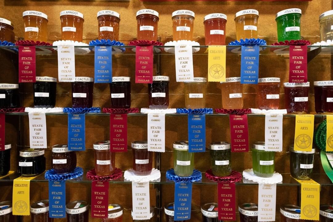Fact #5- Canning is a method for preserving food. These jars are filled with jellies. There are over 100 individually owned orchards and farms – that belong to the Texas Fruit Growers Association – growing fruit, vegetables and melons you can find at farmer’s markets across Texas. 🍇🍓🍒🍊Enter your best preserve in the 2019 Creative Arts Canning competition. #BigTex #StateFairofTX #TexasFacts #NationalAgDay #NationalAgricultureDay #Canning #CreativeArts